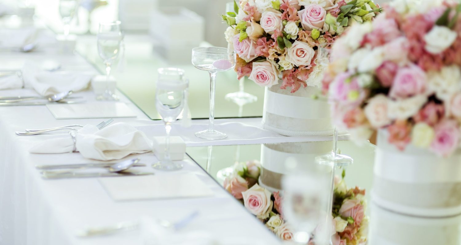 Beautiful wedding decoration with roses and a luxurious table setting